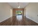 Hardwood floors and neutral walls create a serene atmosphere in the open-concept living room with natural light at 3844 Bedford Ave, Winter Haven, FL 33884
