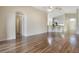 Bright and open living area with hardwood floors, leading into the kitchen with bar stool seating at 3844 Bedford Ave, Winter Haven, FL 33884