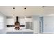 Bright kitchen featuring white cabinets, stainless steel appliances, a center island, and modern lighting at 404 Miami Way, Kissimmee, FL 34759