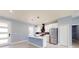 Open kitchen with a center island, stainless steel appliances, white cabinetry and modern pendant lighting at 404 Miami Way, Kissimmee, FL 34759