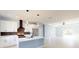 Modern kitchen with white cabinets, stainless steel appliances, and a center island with pendant lighting at 404 Miami Way, Kissimmee, FL 34759