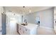 Stylish kitchen with a center island featuring a double sink, stainless steel appliances, and modern lighting at 404 Miami Way, Kissimmee, FL 34759