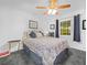 Comfortable bedroom with soft carpeting, a ceiling fan, and natural light from the window at 409 N 6Th St, Lake Hamilton, FL 33851