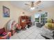 Bedroom in need of decluttering but featuring tile floors and a ceiling fan at 409 N 6Th St, Lake Hamilton, FL 33851
