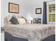 Serene bedroom with a patterned bedspread, dark curtains, and framed artwork at 409 N 6Th St, Lake Hamilton, FL 33851