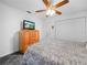 Comfortable bedroom featuring a ceiling fan, dresser with TV, and a closet at 409 N 6Th St, Lake Hamilton, FL 33851