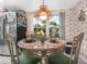 Cozy breakfast nook featuring a round table, chandelier lighting, and an inviting view of the backyard at 409 N 6Th St, Lake Hamilton, FL 33851