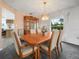 Bright dining room featuring a wooden table with seating for six and a view of the backyard at 409 N 6Th St, Lake Hamilton, FL 33851