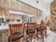 View of the kitchen and breakfast bar with seating for four, adjacent to a stone fireplace feature at 409 N 6Th St, Lake Hamilton, FL 33851