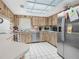 Functional kitchen with stainless steel appliances, wood cabinets, and a bright skylight at 409 N 6Th St, Lake Hamilton, FL 33851