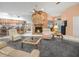 Spacious living room boasting a stone fireplace, comfortable seating, and an open view to the kitchen area at 409 N 6Th St, Lake Hamilton, FL 33851