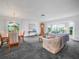 Large living and dining area with ample natural light and neutral carpeting at 409 N 6Th St, Lake Hamilton, FL 33851
