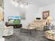 Cozy living room features neutral tones, plush seating, and a mounted television at 409 N 6Th St, Lake Hamilton, FL 33851