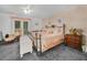 Spacious main bedroom featuring patterned wallpaper, a ceiling fan, and a slider door at 409 N 6Th St, Lake Hamilton, FL 33851