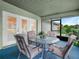 Screened patio area with seating and views of the yard through sliding glass windows at 409 N 6Th St, Lake Hamilton, FL 33851
