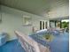 Enclosed patio features comfortable seating and views of the landscaped backyard at 409 N 6Th St, Lake Hamilton, FL 33851
