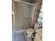 Cozy bathroom featuring a walk-in shower with glass door, toilet, and metal shelving unit at 418 Tivoli Park Dr, Davenport, FL 33897
