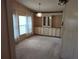 Cozy dining room featuring built-in cabinets, a decorative light fixture, and neutral carpeting at 418 Tivoli Park Dr, Davenport, FL 33897