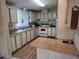 Functional kitchen with wood-look counters, white cabinets, and essential appliances at 418 Tivoli Park Dr, Davenport, FL 33897