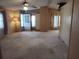 Spacious living room featuring neutral carpet, a ceiling fan, and lots of natural light at 418 Tivoli Park Dr, Davenport, FL 33897