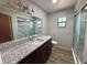Bathroom features granite countertops, modern vanity and frameless glass shower enclosure at 4211 Sunny Land Dr, Lakeland, FL 33813