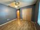 Bedroom with wood-look tile flooring, ceiling fan and closet at 4211 Sunny Land Dr, Lakeland, FL 33813