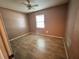 Bedroom with wood-look tile flooring, ceiling fan and one window at 4211 Sunny Land Dr, Lakeland, FL 33813