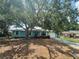 Charming single-story home with a lush green front yard and a large mature shade tree at 4211 Sunny Land Dr, Lakeland, FL 33813