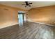 Spacious living room with wood-look tile flooring and neutral walls, perfect for entertaining at 4211 Sunny Land Dr, Lakeland, FL 33813