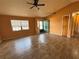 Inviting living room with wood-look tile flooring, a ceiling fan, and plenty of natural light at 4211 Sunny Land Dr, Lakeland, FL 33813