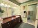 Bright bathroom with a large mirror, vanity, and decorative wall accents at 426 Gleneagles Ct, Winter Haven, FL 33884