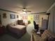Comfortable bedroom with a ceiling fan, large windows, and attached bathroom at 426 Gleneagles Ct, Winter Haven, FL 33884