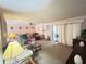 Spacious living room with plush carpet, lots of natural light, and sliding glass door at 426 Gleneagles Ct, Winter Haven, FL 33884