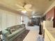 Spacious carpeted living room with ceiling fans, a sofa and a table with chairs at 426 Gleneagles Ct, Winter Haven, FL 33884