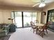 Bright living room with a ceiling fan, sliding glass doors and a cat tree at 426 Gleneagles Ct, Winter Haven, FL 33884