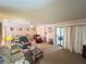 Bright living room offers comfortable seating, neutral decor, and access to outdoor space at 426 Gleneagles Ct, Winter Haven, FL 33884