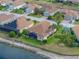 An aerial view of a well-kept house showcasing its screened-in patio, landscaping, and proximity to other homes at 4327 Gullane Dr, Lake Wales, FL 33859
