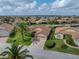 Aerial view of a beautiful home in a waterside community with lush landscaping and a brick driveway at 4327 Gullane Dr, Lake Wales, FL 33859