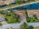 Aerial shot of a home with manicured landscaping, palm trees, and a screened-in lanai at 4327 Gullane Dr, Lake Wales, FL 33859