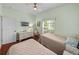 Comfortable bedroom featuring twin beds, wood floors, and a bright, airy atmosphere at 4327 Gullane Dr, Lake Wales, FL 33859