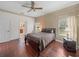 Bedroom featuring hardwood floors, a ceiling fan, and large windows for natural light plus en-suite at 4327 Gullane Dr, Lake Wales, FL 33859