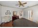 Bedroom featuring an en-suite, hardwood floors, and a ceiling fan, showcasing natural light at 4327 Gullane Dr, Lake Wales, FL 33859