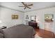 Well-lit bedroom featuring an en-suite, hardwood floors, and a ceiling fan at 4327 Gullane Dr, Lake Wales, FL 33859