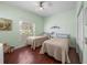 Cozy bedroom features two twin beds, wood floors, and a tranquil ambiance at 4327 Gullane Dr, Lake Wales, FL 33859
