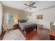 Spacious bedroom with hardwood floors, a ceiling fan, and large windows providing plenty of natural light at 4327 Gullane Dr, Lake Wales, FL 33859