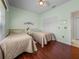 Bright bedroom with two twin beds, wood floors, and an inviting ambiance at 4327 Gullane Dr, Lake Wales, FL 33859