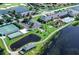 An aerial view of community amenities showcasing tennis courts, a clubhouse, a pool, and a pond at 4327 Gullane Dr, Lake Wales, FL 33859