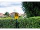 Community safety sign: 'Slow Down, Pets at Play,' amid green hedges and residential background at 4327 Gullane Dr, Lake Wales, FL 33859