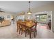 Open-concept dining area showing the living room, and view to the outdoor space at 4327 Gullane Dr, Lake Wales, FL 33859
