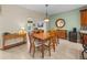 View of dining area with wooden table set, breakfast bar, and neutral-toned walls at 4327 Gullane Dr, Lake Wales, FL 33859